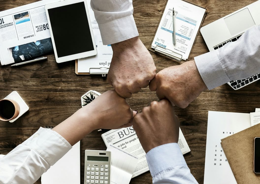 People at a concert facing the stage with various colours of paint powder in the air